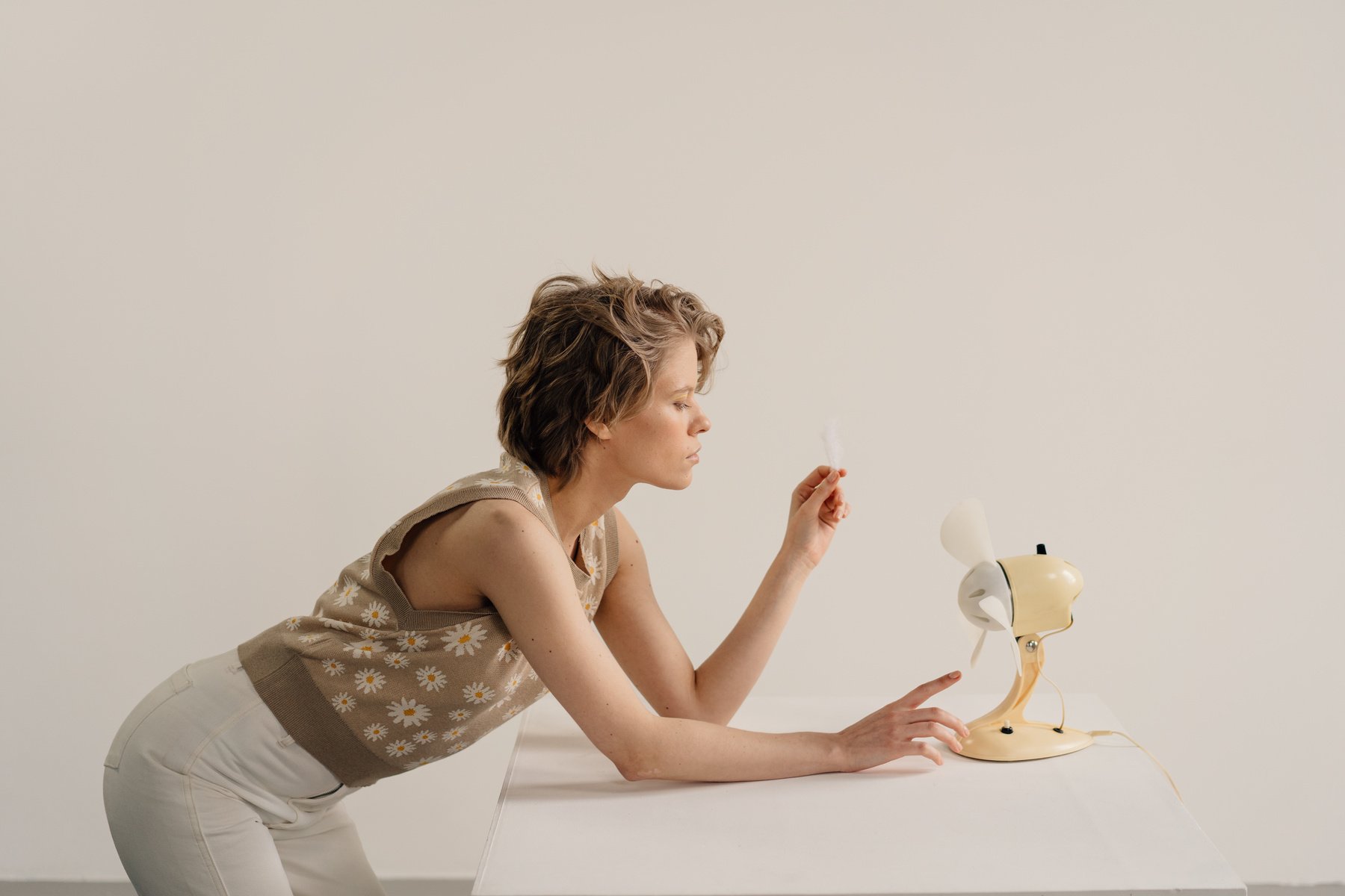 A Woman Looking the Desk Fan